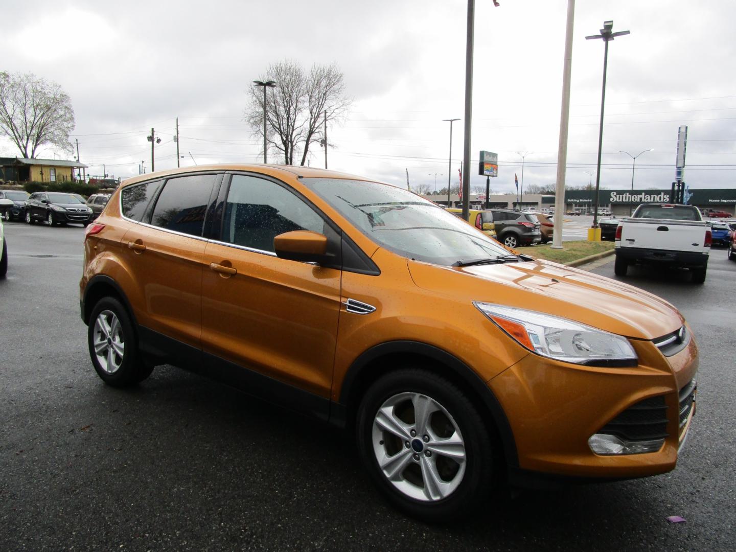 2016 Orange /Tan / Cloth Ford Escape SE 4WD (1FMCU9GX0GU) with an 1.6L L4 DOHC 16V engine, 6-Speed Automatic transmission, located at 1814 Albert Pike Road, Hot Springs, AR, 71913, (501) 623-1717, 34.494228, -93.094070 - Photo#3